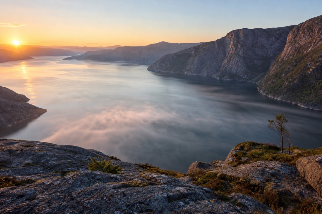 Empty fjord viewpoint at sunrise with mist on the water and no visitors