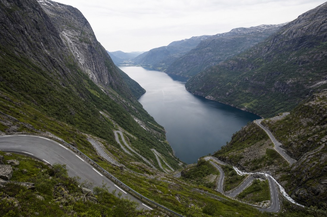 Fjord seen from a high road viewpoint with switchbacks visible below and water far beneath
