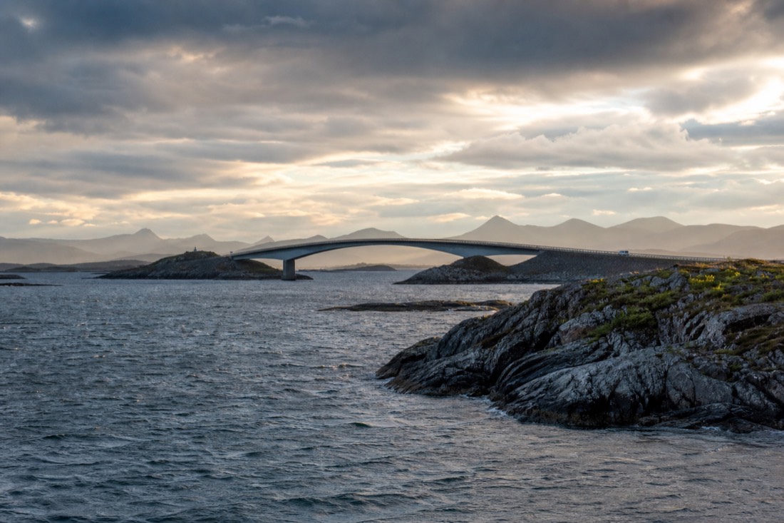 The curving Atlantic Road bridge arcing over open sea between rocky islets on Norway's west coast