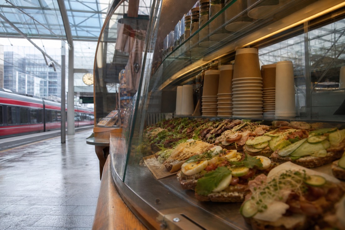 Bakery counter with open sandwiches and coffee in a Norwegian train station hall