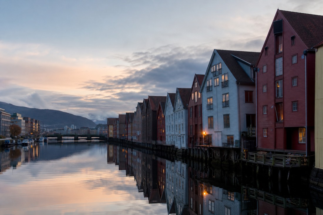Bergen harbour at dawn with wooden warehouse facades reflected in still water