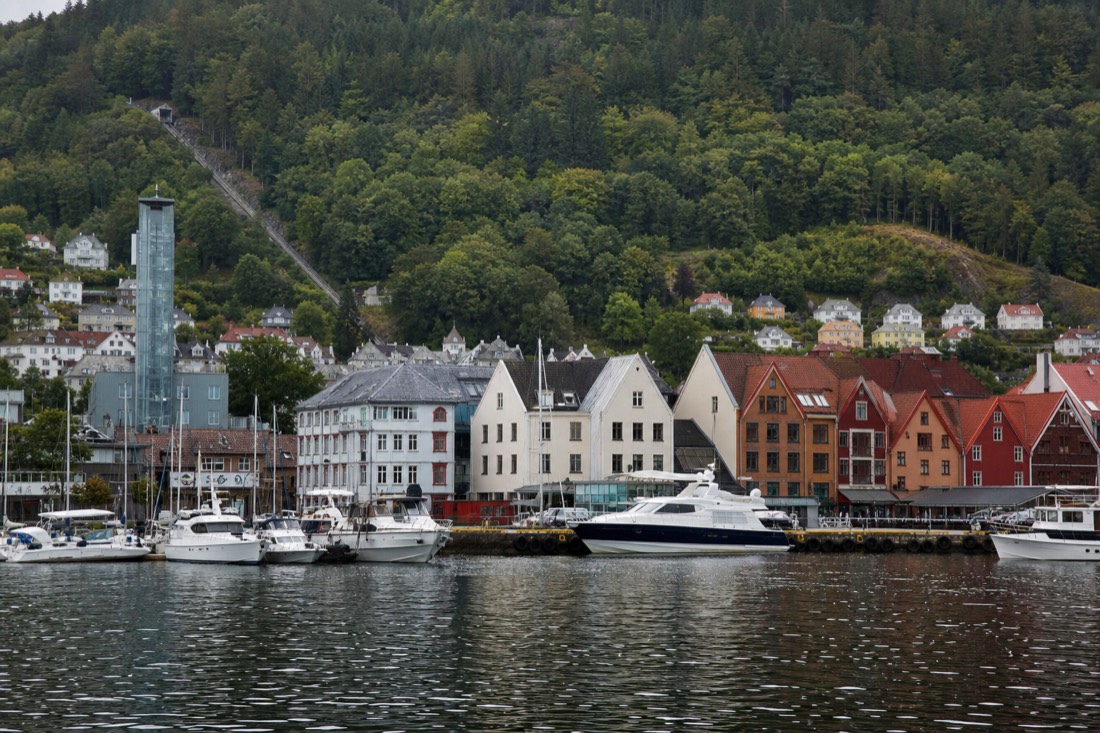 Bergen harbour with the funicular hillside behind and boats moored along the quay